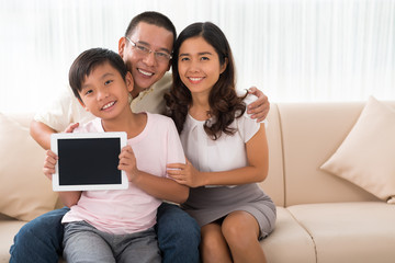 Family with digital tablet