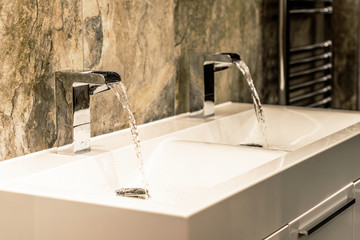 Double bathroom basins fading to suggest setting.