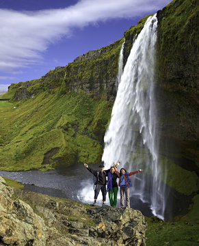 Group of climbers waterfall background