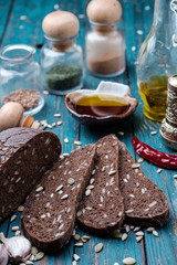 Traditional dark bread with sunflower seeds on a wooden table.