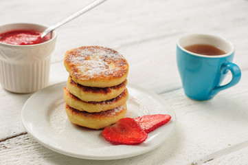 Breakfast with cottage cheese pancakes, strawberry jam and coffe