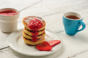Breakfast with cottage cheese pancakes, strawberry jam and coffe