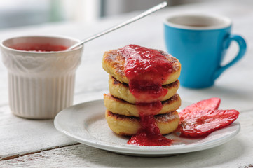 Breakfast with cottage cheese pancakes, strawberry jam and coffe