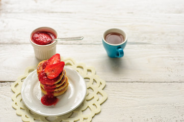 Breakfast with cottage cheese pancakes, strawberry jam and coffe