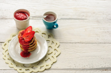 Breakfast with cottage cheese pancakes, strawberry jam and coffe