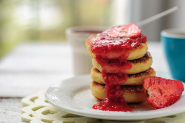 Breakfast with cottage cheese pancakes, strawberry jam and coffe