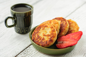 Breakfast with cottage cheese pancakes, strawberry jam and coffe