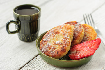 Breakfast with cottage cheese pancakes, strawberry jam and coffe
