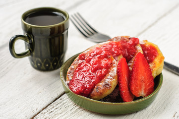 Breakfast with cottage cheese pancakes, strawberry jam and coffe