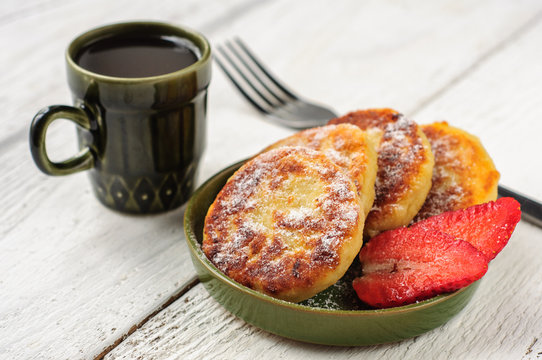 Breakfast with cottage cheese pancakes, strawberry jam and coffe