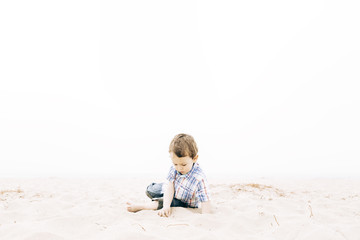 little boy playing on beach in holidays at outdoors