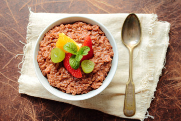 Bowl with pudding with fruits and mint leafs