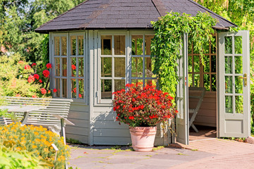Outdoor wooden gazebo at sunset on summer evening