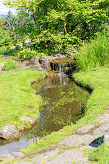 Fototapeta na wymiar Decorative pond with waterfall at Oslo city park