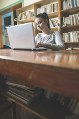 Student girl and laptop in a library