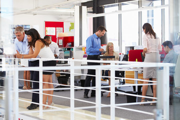 Staff working in a busy office mezzanine