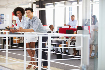 Staff working in a busy office mezzanine