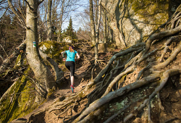 Naklejka premium Female running on the hard trail