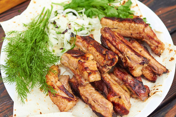 grilled ribs on fire with vegetables