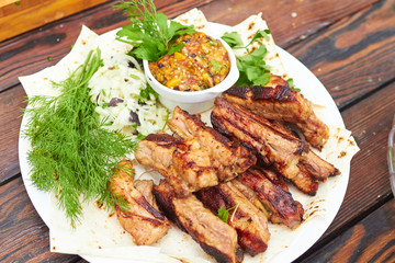 grilled ribs on fire with vegetables