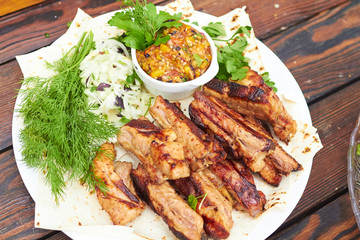 grilled ribs on fire with vegetables