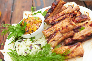 grilled ribs on fire with vegetables