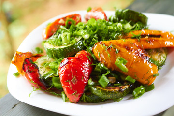 dish with grilled sweet peppers, zucchini, green onions and herb