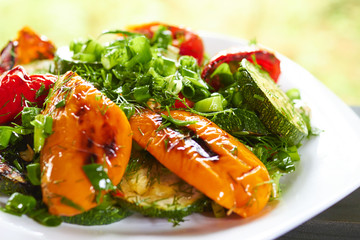 dish with grilled sweet peppers, zucchini, green onions and herb