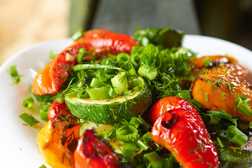dish with grilled sweet peppers, zucchini, green onions and herb
