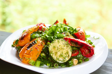 dish with grilled sweet peppers, zucchini, green onions and herb