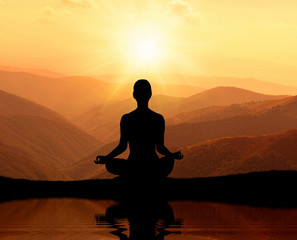  Man meditating in yoga position on the top of mountains - obrazy, fototapety, plakaty
