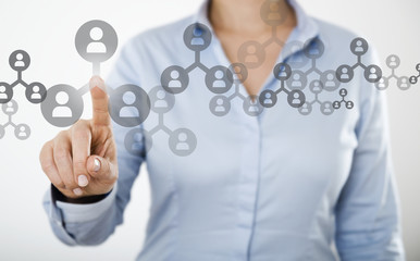 Businesswoman pressing people icon on the digital touch screen