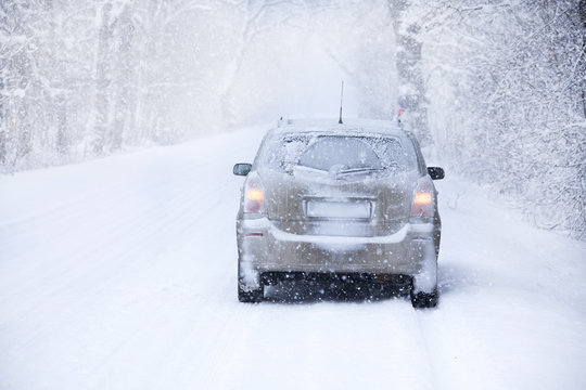 Car On The Winter Road In Snowstorm Time