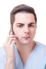 Male doctor talking on smartphone
