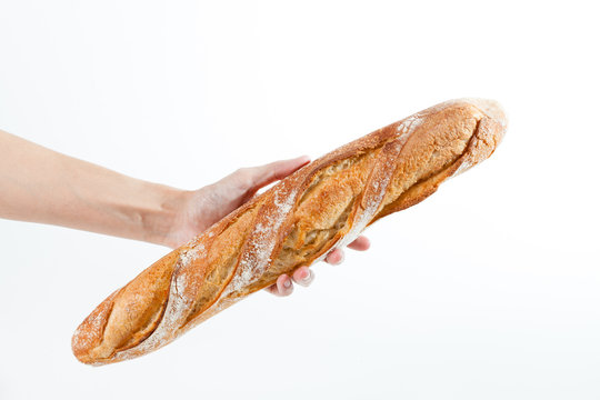 Hand holding a French baquette
