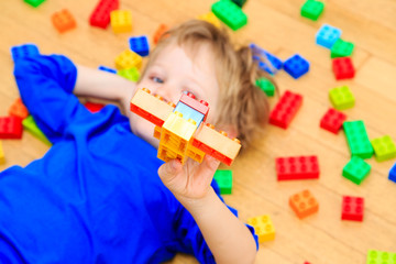 child playing with colorful plastic blocks indoor