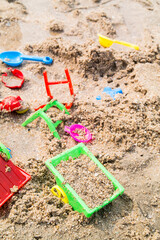 Children's toys on a sand beach