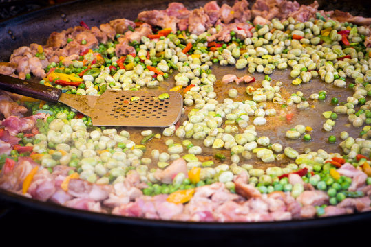 Traditional spanish paella preparation, outdoors food market