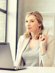 woman with laptop and finger up