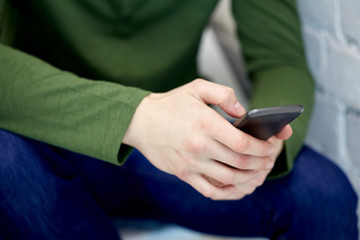 close up of male hands with smartphone