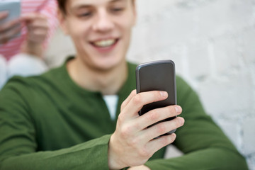 close up of young man with smartphone