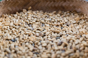 close up of unroasted coffee beans in basket