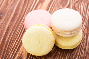 A lot of french colorful cookies on wooden