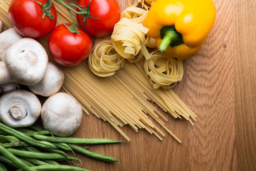 Pasta with some vegetables, wooden background