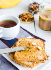 crispy toast with peanut butter, bananas, coffee, breakfast