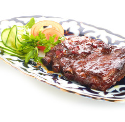 Meat on a grill with vegetables