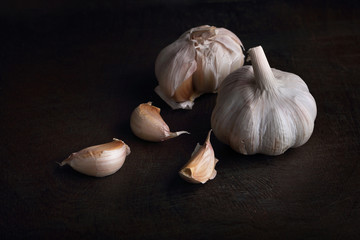 Garlic cloves on the black wooden table