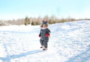 Fototapeta na wymiar Happy child walking in sunny winter day