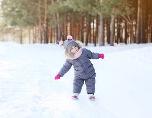 Fototapeta na wymiar Positive child having fun in winter day