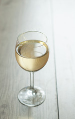 white wine in glass on vintage background